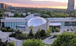 Ontario Science Centre - modern concrete building with trees and city in background